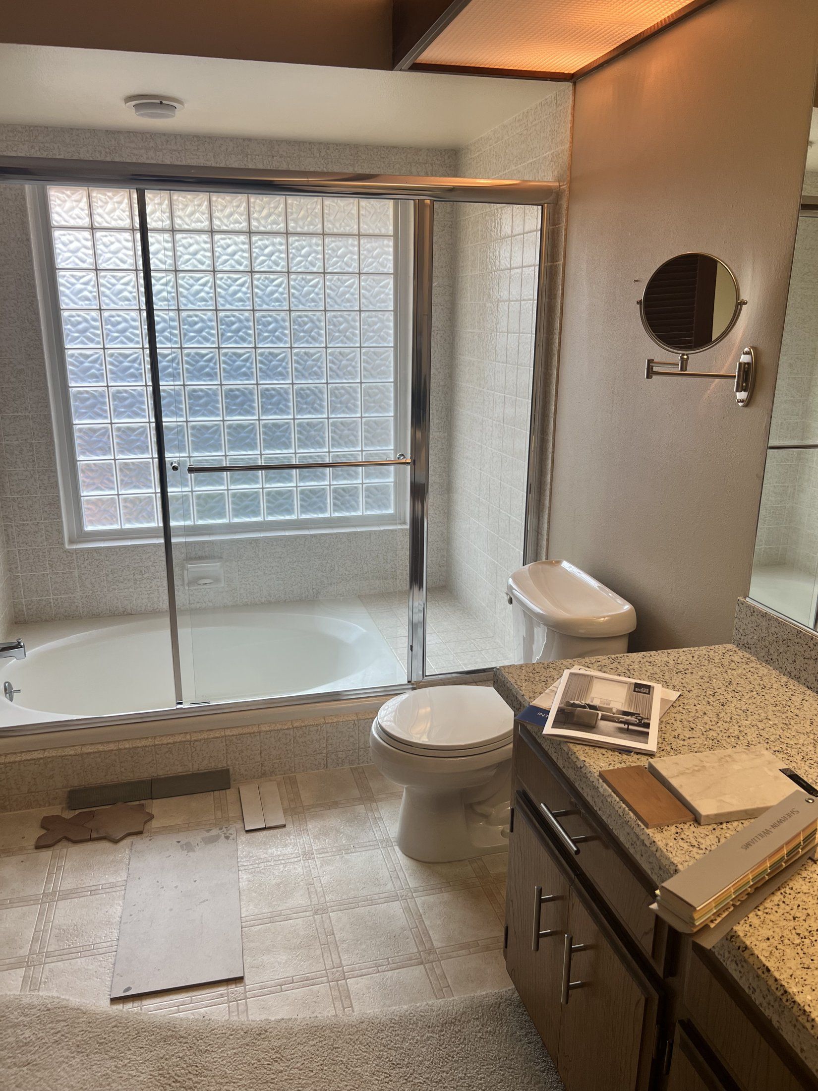 Before: sunken tub below a glass-block wall