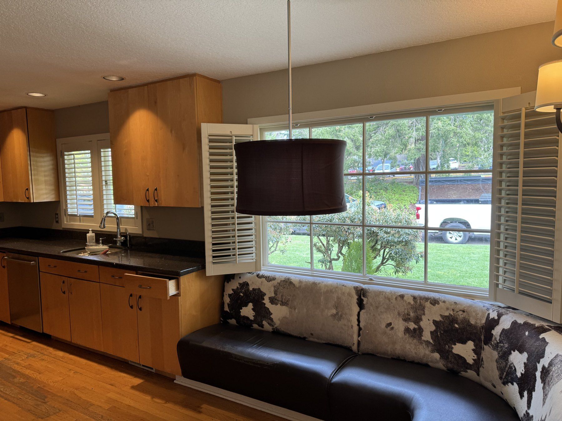 Before: window nook with a built-in bench beside the original wood cabinets